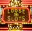 Bright neon lights display the words 'Loose Slots' with a dollar sign in the center. The sign is outlined with bulbs, creating a vibrant and flashy effect typical of a casino or entertainment venue.